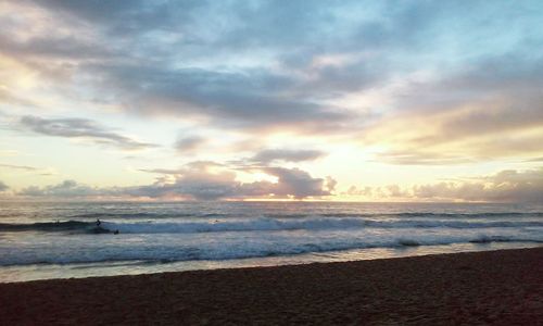 Scenic view of sea against cloudy sky