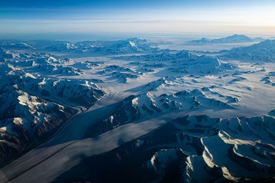 Aerial view of snowcapped mountains against sky