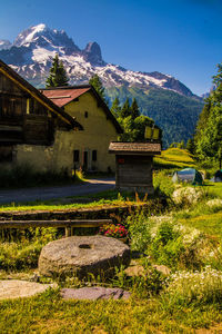 House on field against mountain