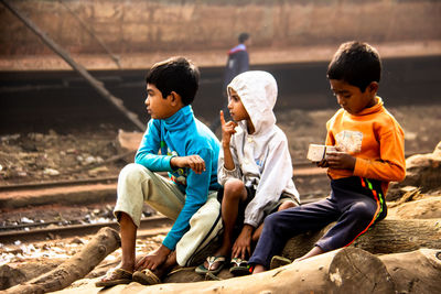 Friends sitting on shore