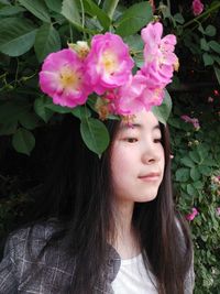 Close-up portrait of beautiful woman with pink flowers