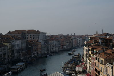 Buildings in city against clear sky