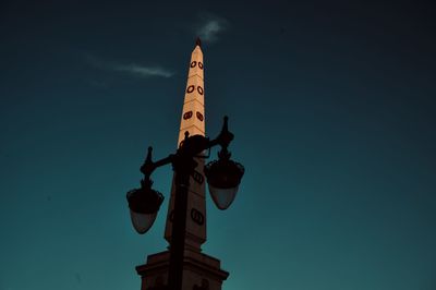 Low angle view of statue against building against sky