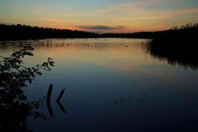 Scenic view of lake at sunset