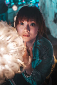 Night portrait with asian girl from taiwan. she wear denim jacket.