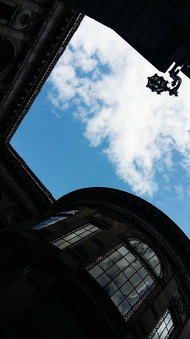 low angle view, architecture, built structure, sky, history, cloud - sky, arch, building, day, travel destinations, cloud, directly below, city, no people, architectural feature, tourism, capital cities, historic, cloudy, tilt