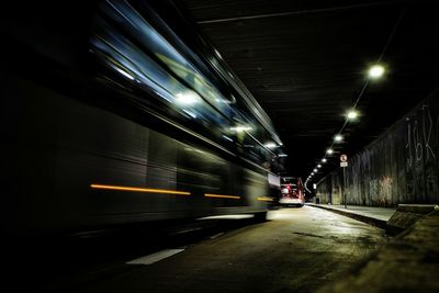 Light trails on illuminated street at night