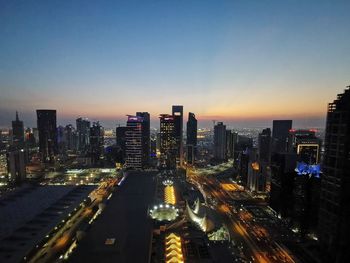 High angle view of illuminated buildings against sky at night