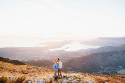 Full length of man standing on mountain against sky