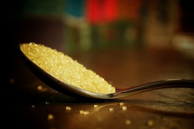 Close-up of sugar in spoon on table