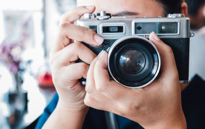 Close-up of woman holding camera