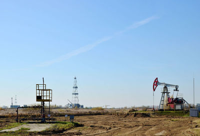 Windmill on field against sky