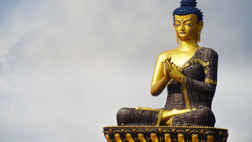 Low angle view of statue against sky