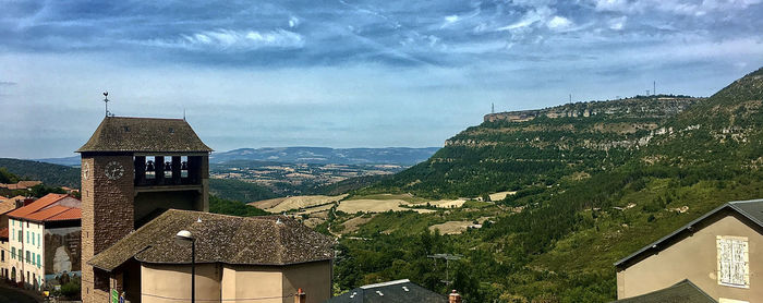 Buildings in town against sky