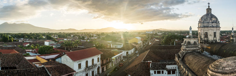 Panoramic view of buildings in town against sky