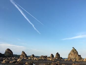 Vapor trail against blue sky