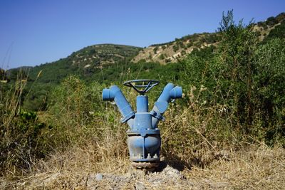 Blue fire hydrant against mountains