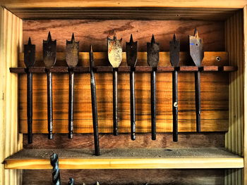 Row of clothes hanging on wooden wall