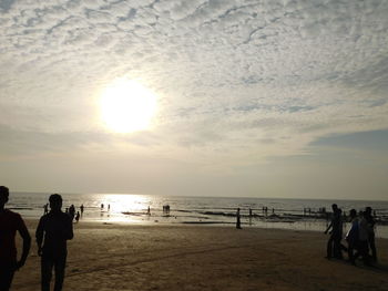 People on beach at sunset