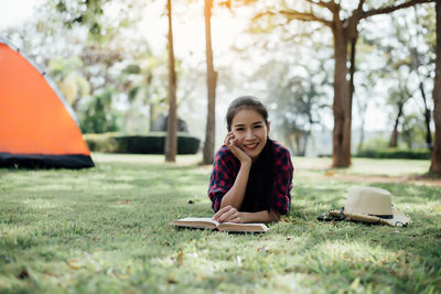 Portrait of smiling young woman sitting outdoors