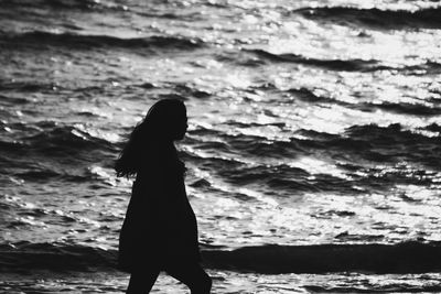 Silhouette woman standing at beach