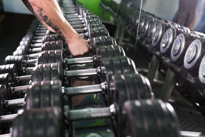 Close-up of person working on metal grate