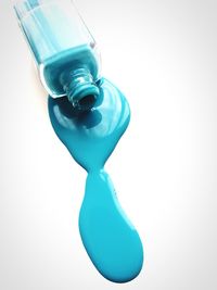 Close-up of blue bottle against white background