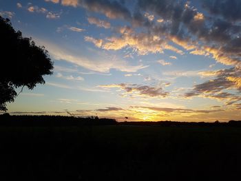 Silhouette landscape against sunset