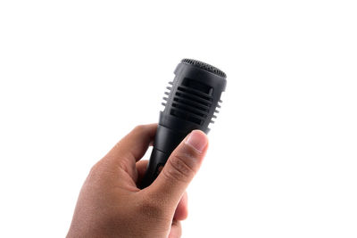Close-up of hand holding camera against white background