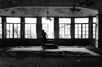 Woman standing in abandoned interior