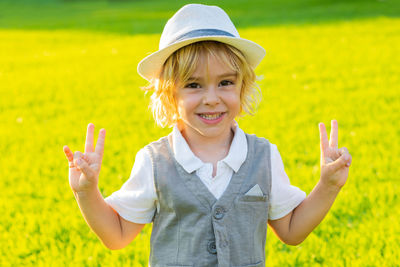 Portrait of smiling girl standing on field