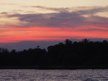 Scenic view of lake against romantic sky at sunset