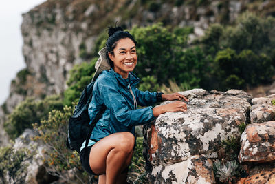 Smiling woman rock climbing