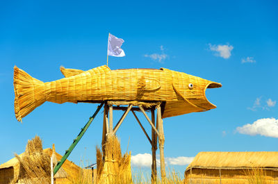 Low angle view of traditional windmill against blue sky