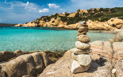 Stack of rocks on beach against sky