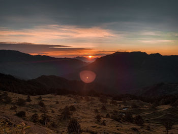 Scenic view of mountains against sky during sunset