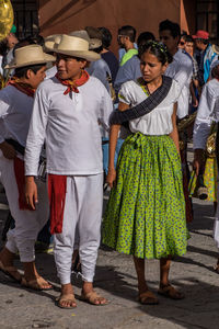 Rear view of people standing outdoors