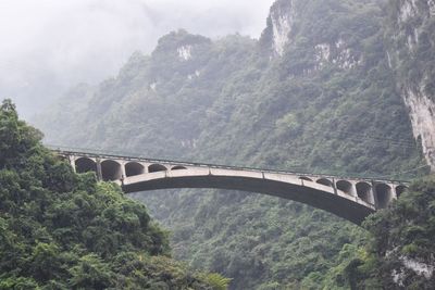 High angle view of bridge over river against mountains