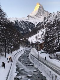 Road leading towards snow covered mountains