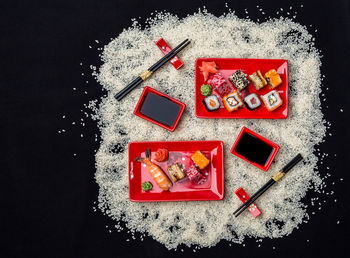 Directly above shot of strawberry cake on table against black background