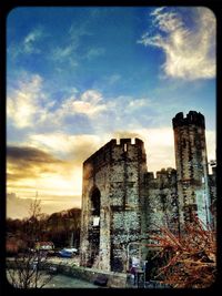 Buildings against cloudy sky