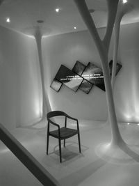 Empty chairs and tables in illuminated room