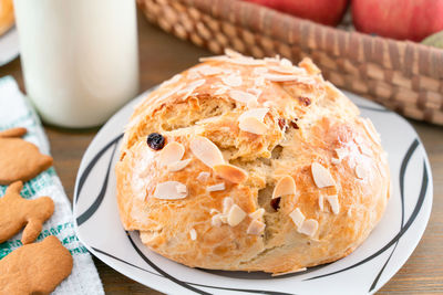 Freshly baked, homemade sweet cake with almonds and raisins on wooden board. easter loaf. 