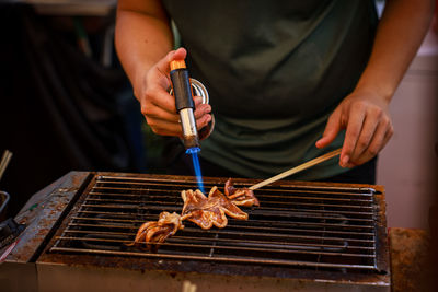 Midsection of man preparing food