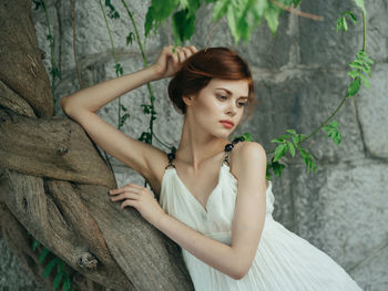 Portrait of young woman looking up