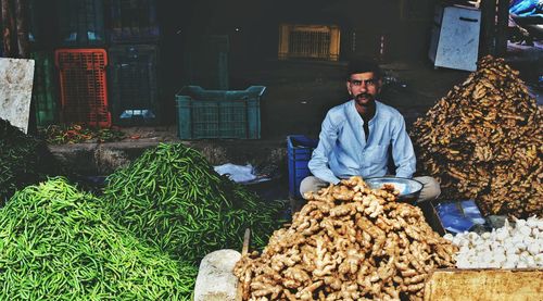 Portrait of vendor with vegetables in market