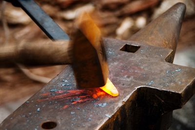 Hammer hitting iron on anvil