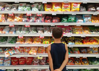 Full length of man having food in store