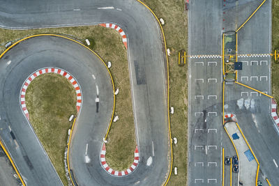 Aerial top view of the go-kart track from the drone. kart racers drive on the open track.