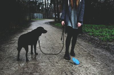 Woman with dog on pathway